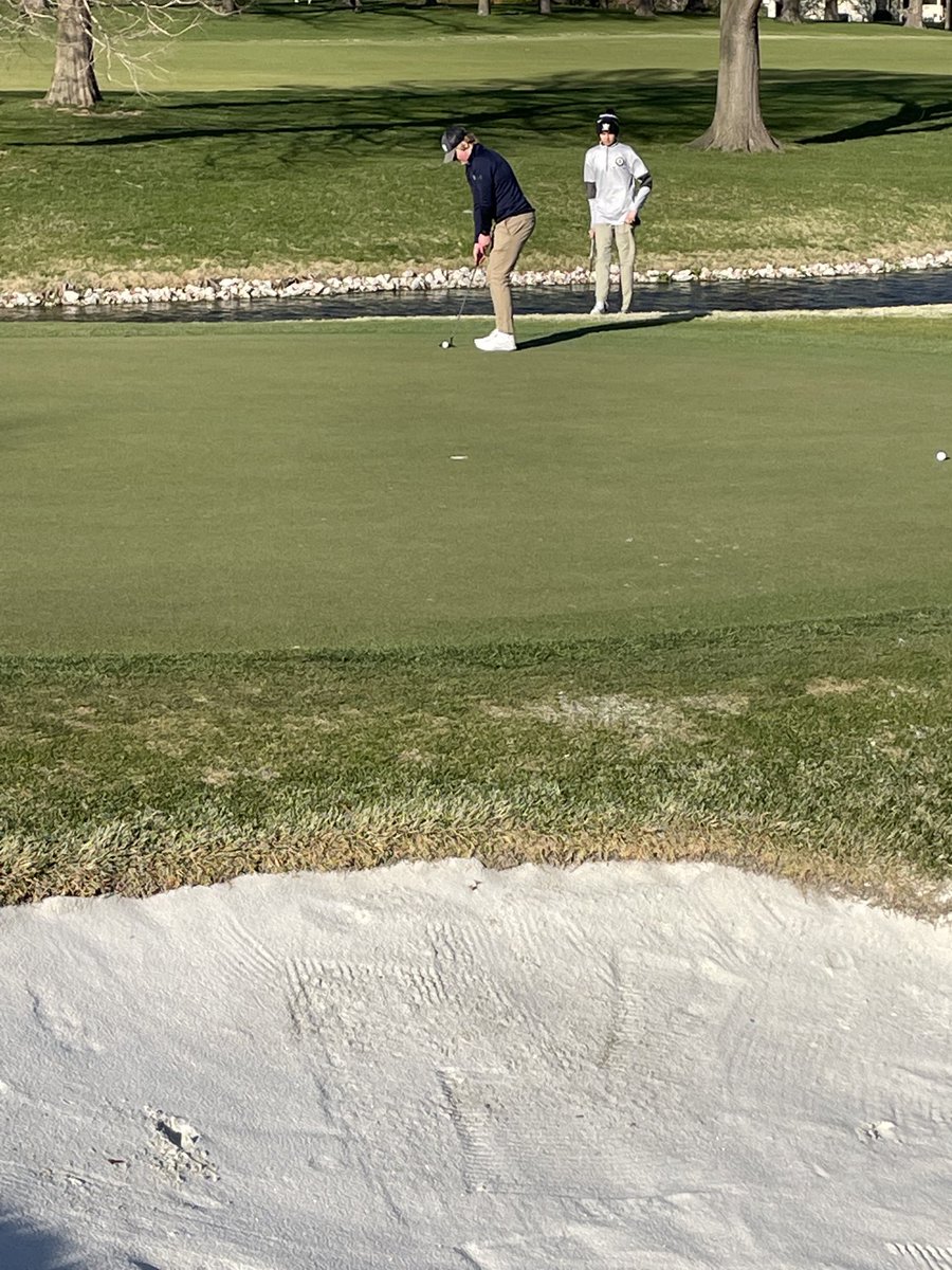 Senior Gus Wylie lines up his par putt on the Par 3 6th hole.