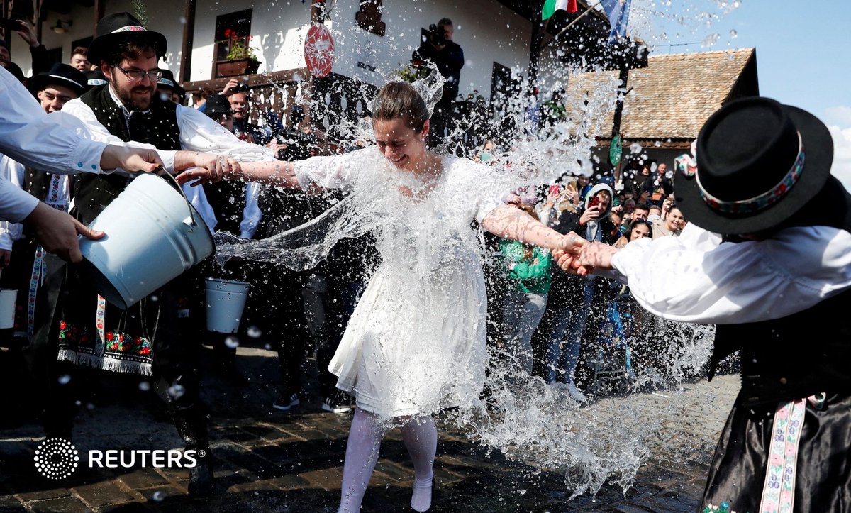 A woman dressed in traditional clothes reacts as men throw water at her during a traditional Easter celebration in Holloko, Hungary. Keep your audiences engaged with Reuters Connect:
