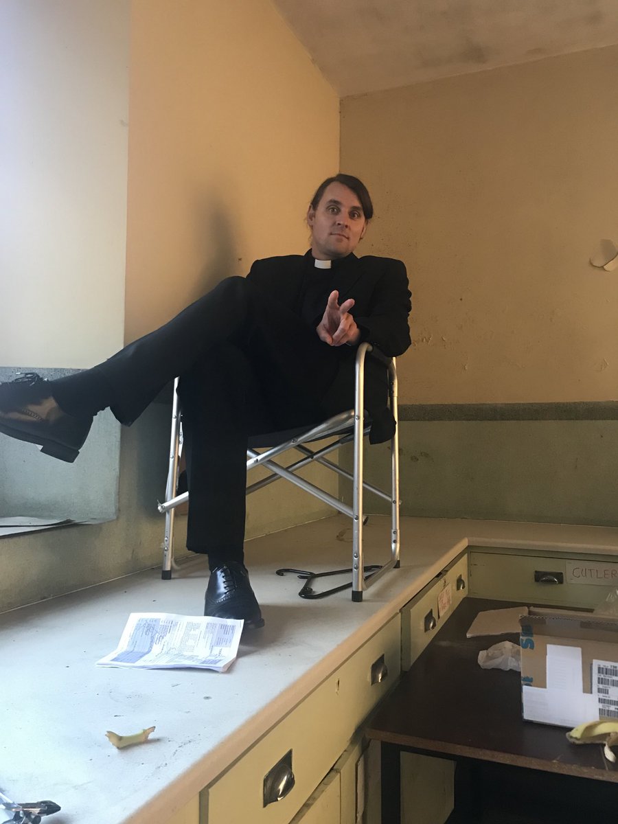 siobhni's tweet photo. GIVE THE PEOPLE WHAT THEY WANT 
In this case Fr.Peter in a camp chair on a deserted freezing  kitchen worktop trying to warm his feet.  Isn’t he lovely. #derrygirls https://t.co/rDuiXuNVvO