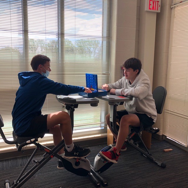 librarylifems's tweet photo. Biking and gaming in the library at lunch! Thanks @ThoreauMS PTA for the bikes! #lunchlife #multitasking https://t.co/U6MqHps3JF
