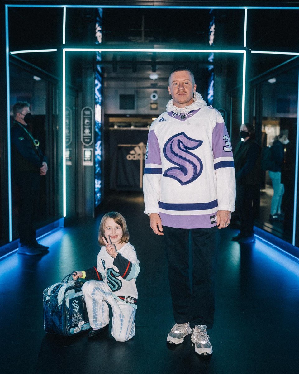 macklemore's tweet photo. First game as an owner kinda hit different.  A night to remember  @SeattleKraken @MoneyLynch.  And Sloane is officially a hockey fan. https://t.co/2js7S769Wf