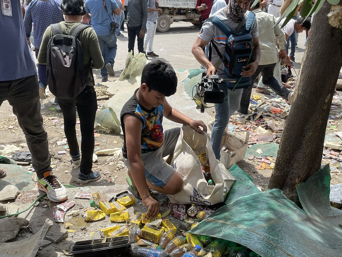 A young boy collecting coins and juice tetra packs after his father’s juice shop was demolished. The family later collected the remaining stuff. 
Via - <a href="/ankitaup/">Ankita Upadhyay</a>