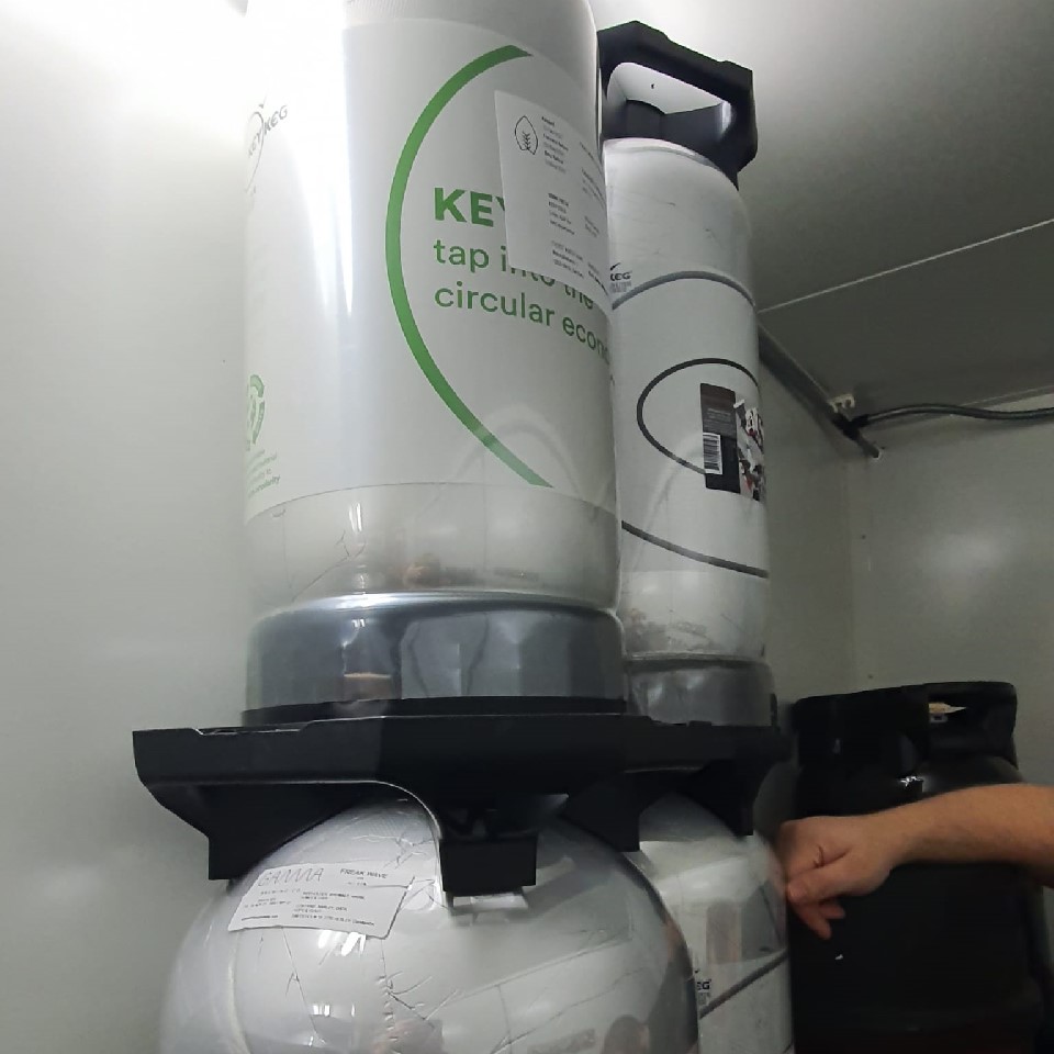 Beer kegs in a walk-in bar cooler.