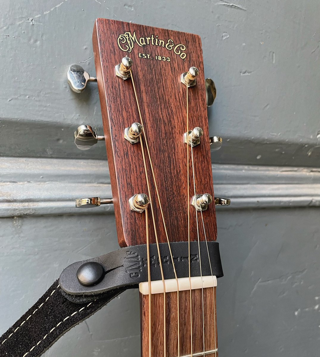 Westside MI on X Perfect for guitars missing the strap button on the heel of the neck this MartinGuitar black leather headstock tie fits neatly under the strings on the headstock to