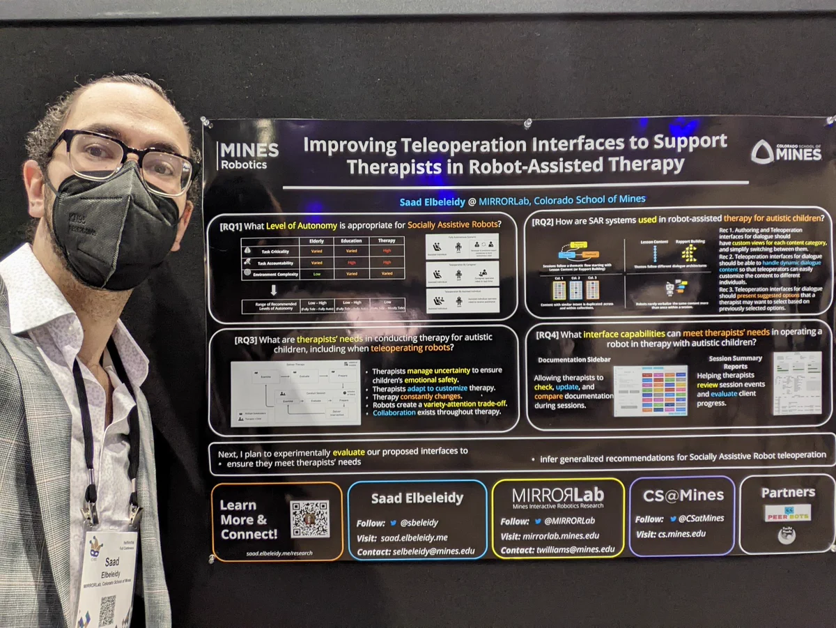 Saad standing next to his poster titled "Improving teleoperation interfaces to support therapists in robot assisted therapy"
