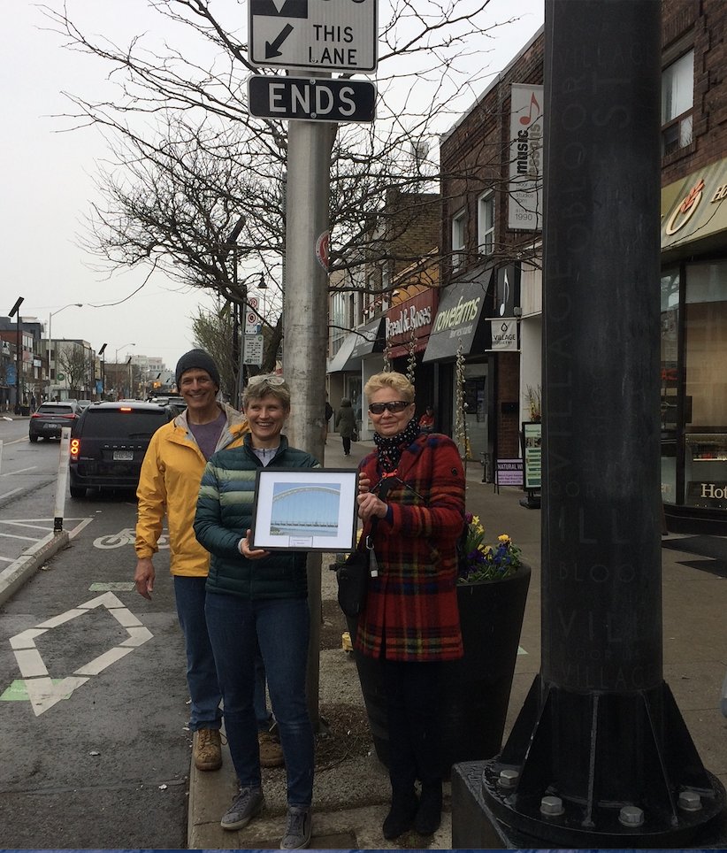 BikewaysTO's tweet photo. RING YOUR BELLS for Ingrid Buday (centre), this year's "Emerging Road Safety Champion" for her innovative contributions to advocacy and her leadership on the We Belong on Bloor campaign to extend Bloor bike lanes west to Mississauga from Runnymede Rd (see the overhead sign). https://t.co/veiacngZ0o