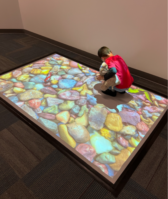 MissBoccella's tweet photo. Students in Room 17 are LOVING the new interactive hallway! We walked on lava, in a ball pit, and saw fish swim in a pond!🌋🐟 #centennial #interactivespace https://t.co/5HHbnboJ46