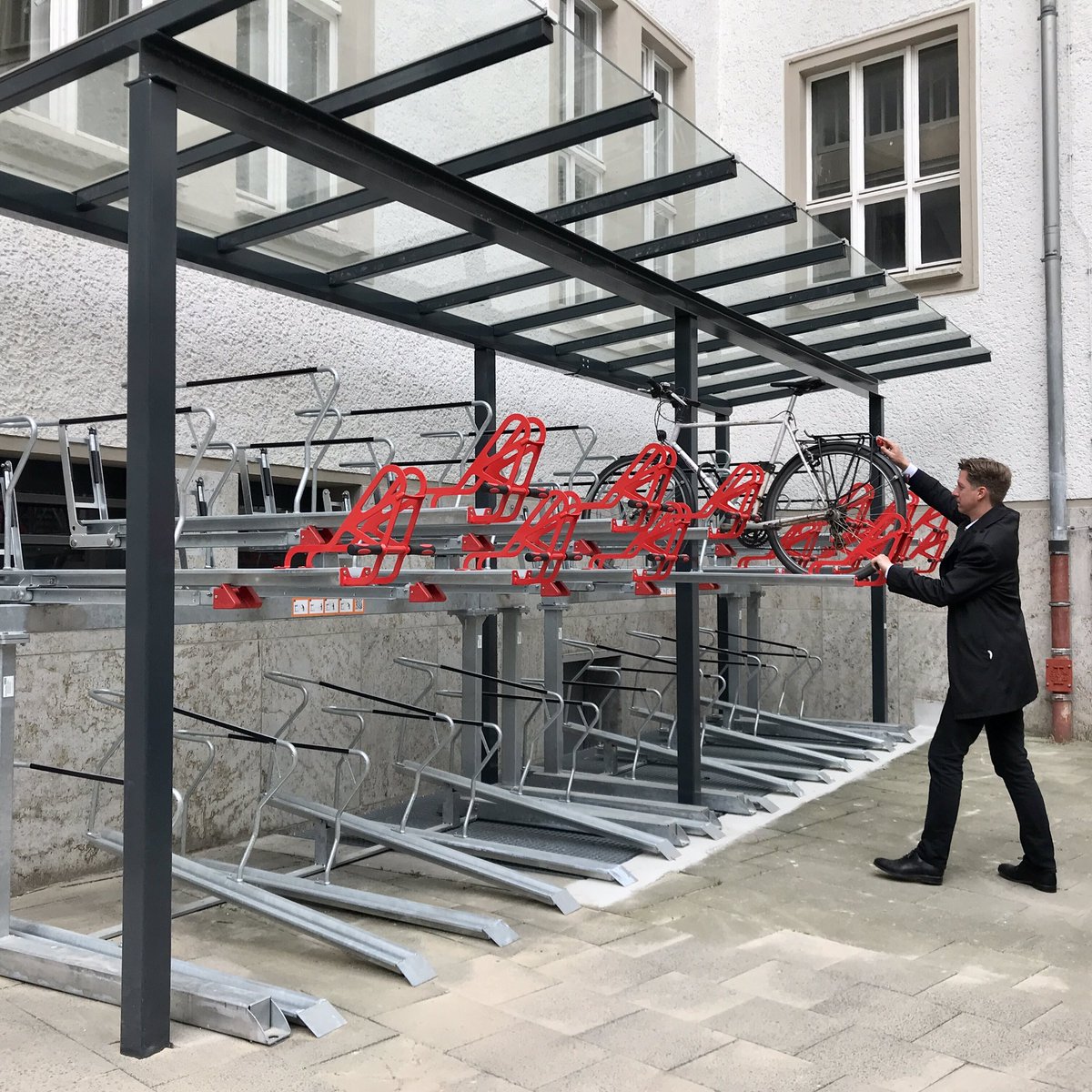 senfin's tweet photo. Klimaneutral und gesund zur Arbeit: Finanzsenator #Wesener testete heute als Erster unsere neuen überdachten, doppelstöckigen Fahrradständer. Diese bieten Platz für 28 weitere Räder und machen #mdrza noch leichter. 🚴🏻‍♂️ 💪🏽 https://t.co/ZivG5lE4S7