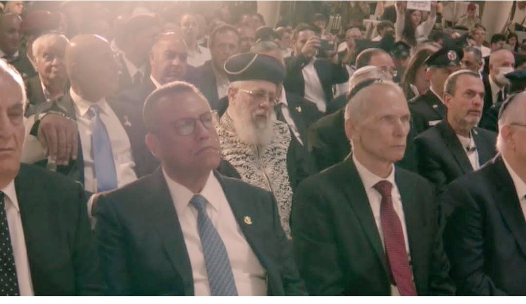 מרן הראשל"צ הרב יצחק יוסף ענוונתן וצדיק . איך הוא יושב בשורה שניה ולא מעניין אותו גינוני כבוד . אבל עלינו למחות כנגד מי שעשה את זה . מלך שמחל על כבודו אין כבודו מחול . 

אני מתפלא על משה ליאון . היה צריך לקום ולחלוק כבוד לרב .