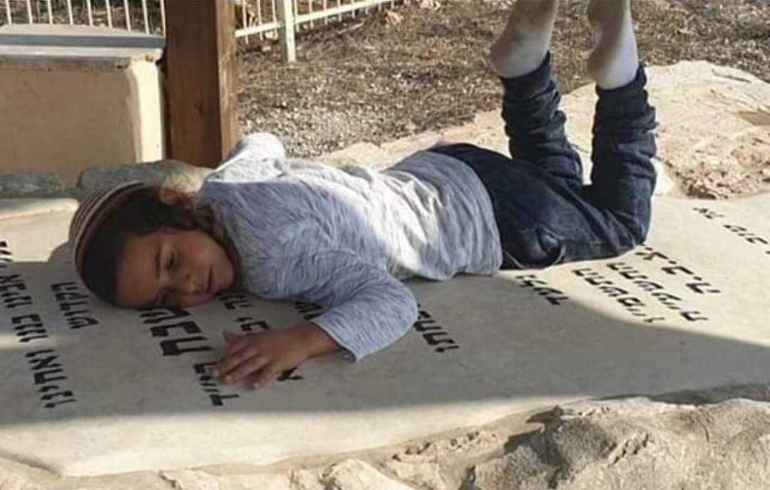 RavJesseHorn's tweet image. Rav Raziel's son hugging his father's (murdered by a terrorist in 2018) kever today on tom hazikaron. Brought me to tears. 

One great Rav once said "I won't ask why, but I will ask for how much longer?"