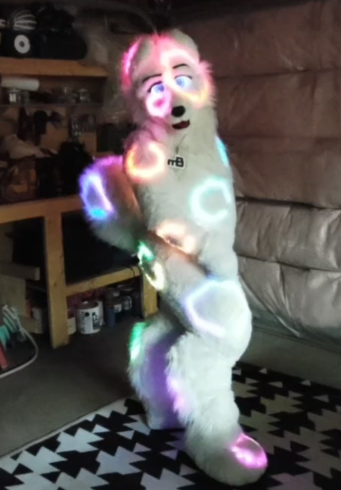 Made2Glow's tweet photo. Since I created my light suit in 2015. I have now updated the system. 536 individually soldered LEDs. Water proofed. Teensy 3.1 with a mic. 42Wh LiFe power. I now have 4 buttons (from 3). LEDs built right into the body. 

Now I match my @VRChat avatar. 

See you at @FurryWeekend https://t.co/hYDeFpVmwE