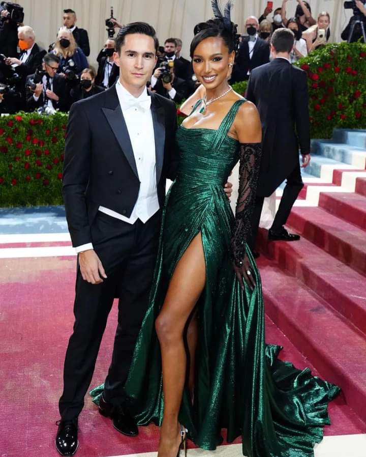 Model @JasTookes, alongside husband @JuanDavidBorrero, looks radiant at the #MetGala2022 wearing a custom #ZuhairMurad Couture emerald green lam pintuck draped sleeveless gown with overlay train & thigh high slit paired with custom Model @JasTookes, alongside husband @JuanDavidBorrero, looks radiant at the #MetGala2022 wearing a custom #ZuhairMurad Couture emerald green lam pintuck draped sleeveless gown with overlay train & thigh high slit paired with custom
