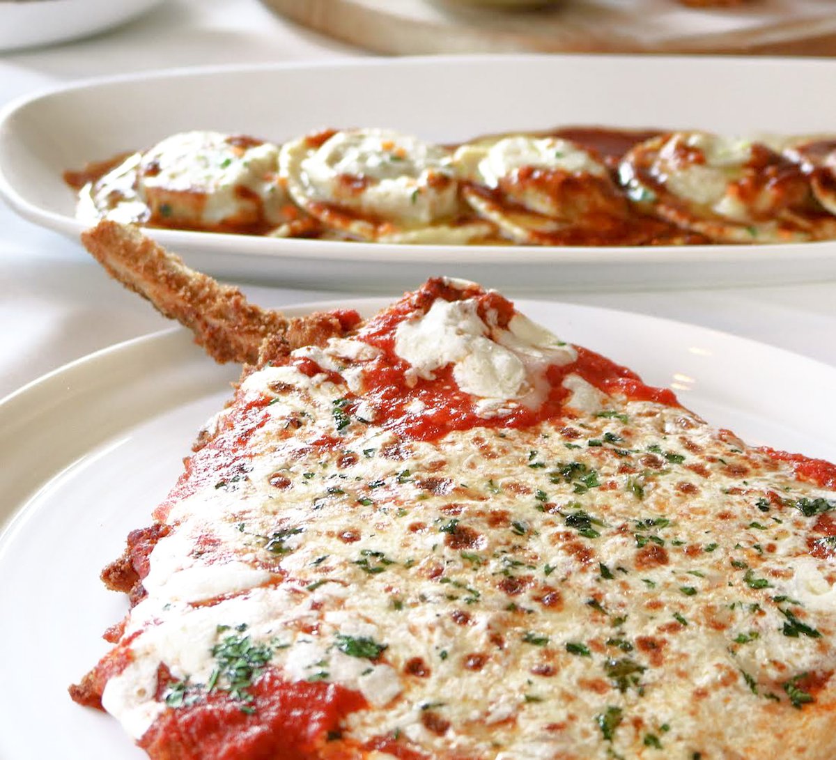 Two Pricci Classics! Our RAVIOLI DI BRASATO and VEAL CHOP PARMIGIANA. Which of the two is your favorite?