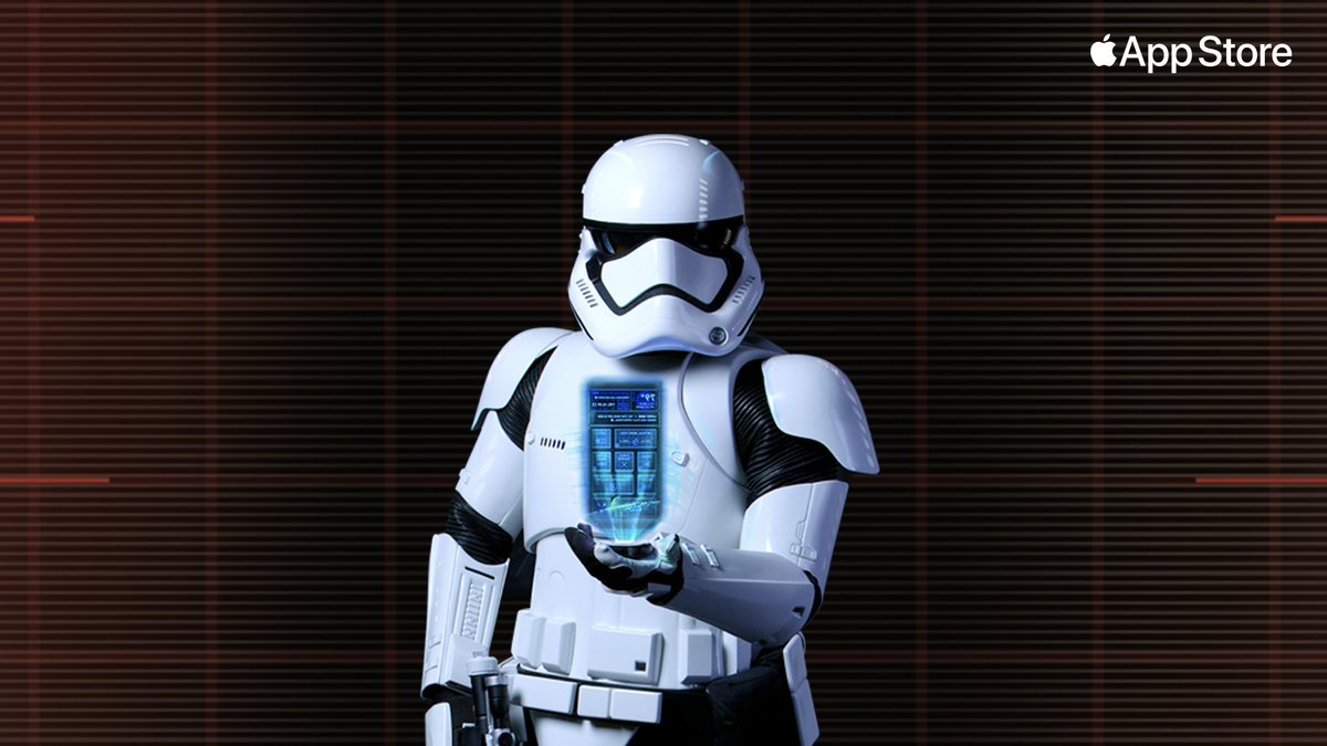 Dark background with red lines and a star wars storm trooper in the middle wearing a full white unifrom/armor including a helmet and mask. In their palm is a phone sized screen with blue colored information on it. 