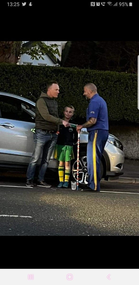 ChristineDemp15's tweet photo. Taken from FB. This little 10yro had been to Gaelic practice and wanted his dad to go see bands(was in awe of them)so still in kit away they went to watch.This pic says it all, it could work if we all accept each other cultures and work together.👏👏to this dad and👏👏to bandsman https://t.co/UPScmlnvpY