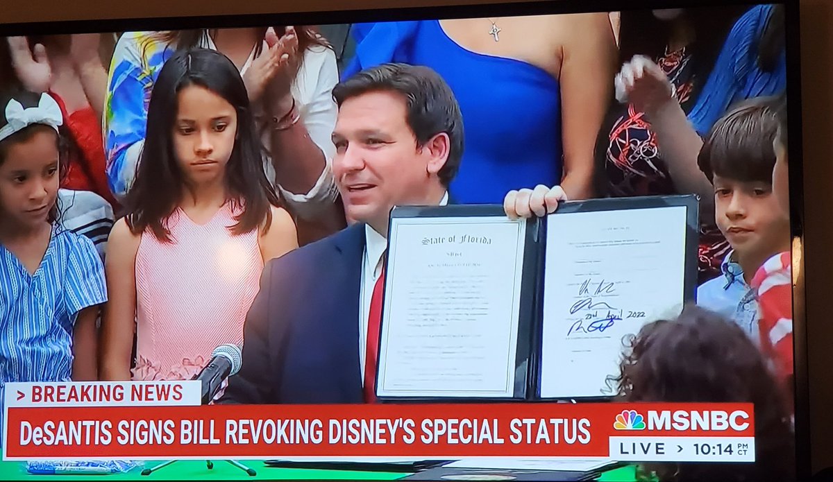 Surrounded by dissapointed children, Florida's Governor punishes Mickey Mouse.