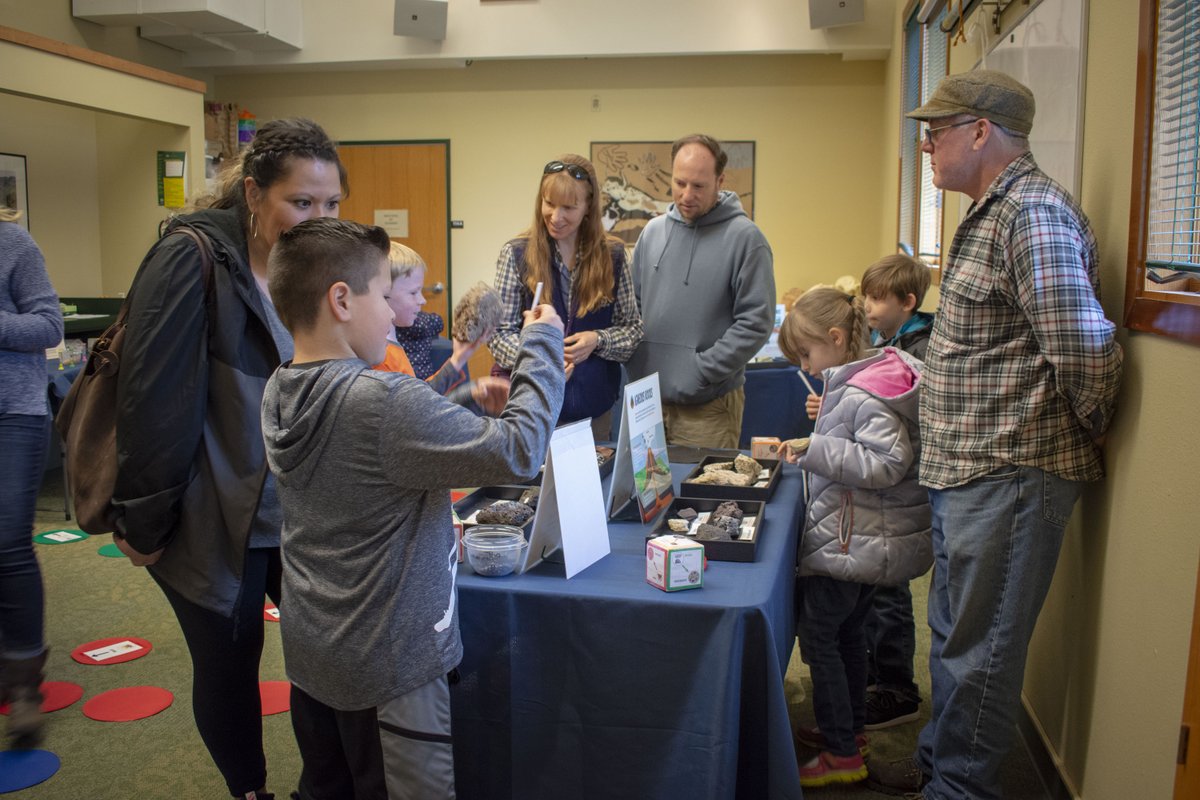 Children and adults surround a table with activities