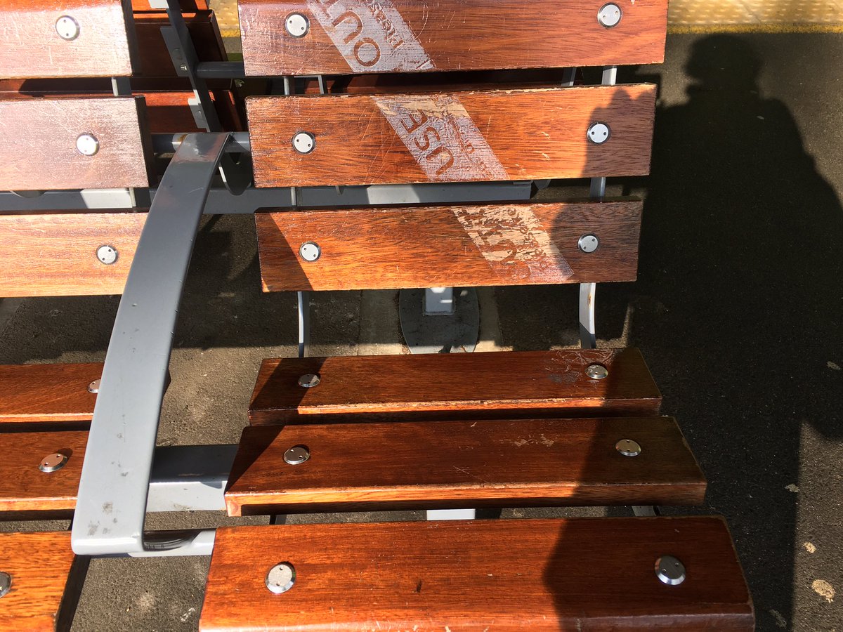 Esther_Gill's tweet photo. The remnants of an ‘out of use’ sticker, a ghostly reminder of a time when station benches were being taped off. Strange traces of the pandemic, one for the #ViralArchive. https://t.co/BWmnU4aMcs