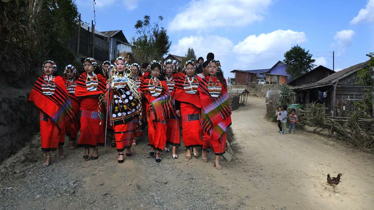 A group of women dressed in traditional Tangkhul Naga attire accompany a bride-to-be as she leaves her village to travel to Manipur’s #Shangshak village, where her groom lives. (PC: AP\Yirmiyan Arthur)
#NorthEastIndia  #Manipur
