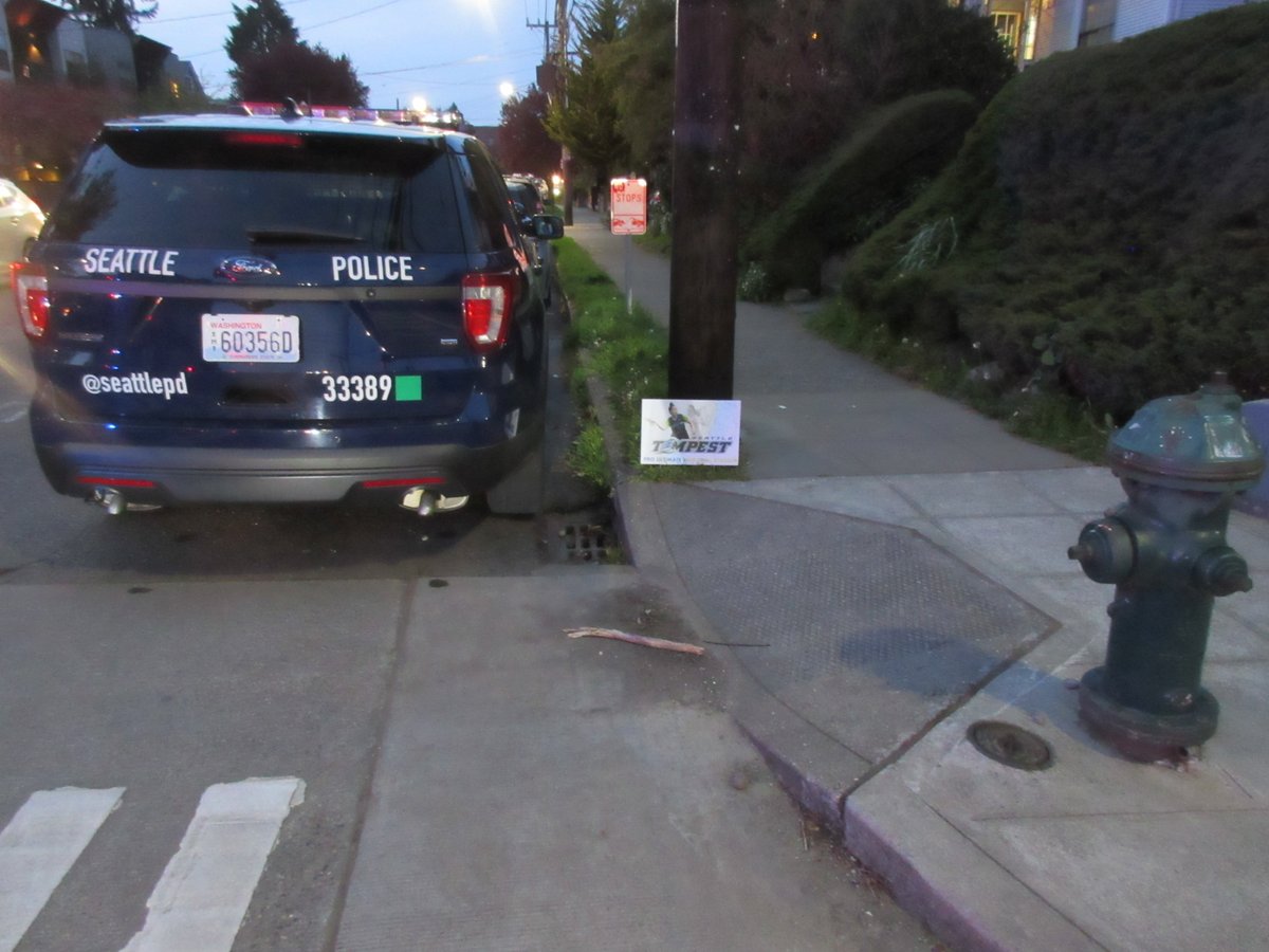 The sign explicitly says No Parking, so SPD parks there and thus encroaches on a curb cut and is less than 15 feet of a fire hydrant.