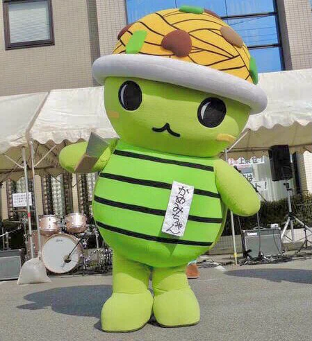 Kamemaru, a turtle with udon noodles on its head, promotes udon from Kameyama City, Japan. 
