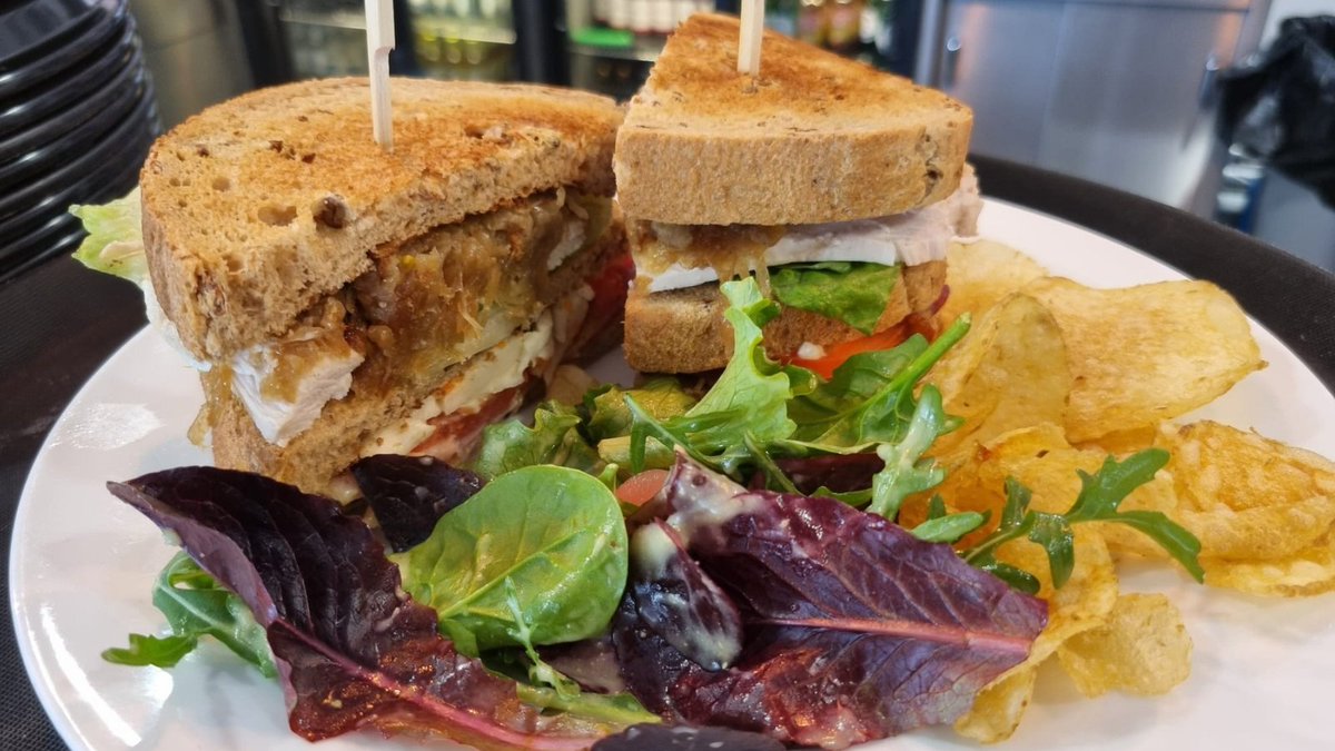 Our three-layer BR6 Club Sandwich contains a generous mix of grilled chicken, crispy bacon, gem lettuce, tomatoes, caramelised onion, slaw &amp; mayo – paired with a side of salted crisps &amp; dressed salad. Only £4.50. Vegan &amp; gluten-free options also available: bit.ly/3MuoixU