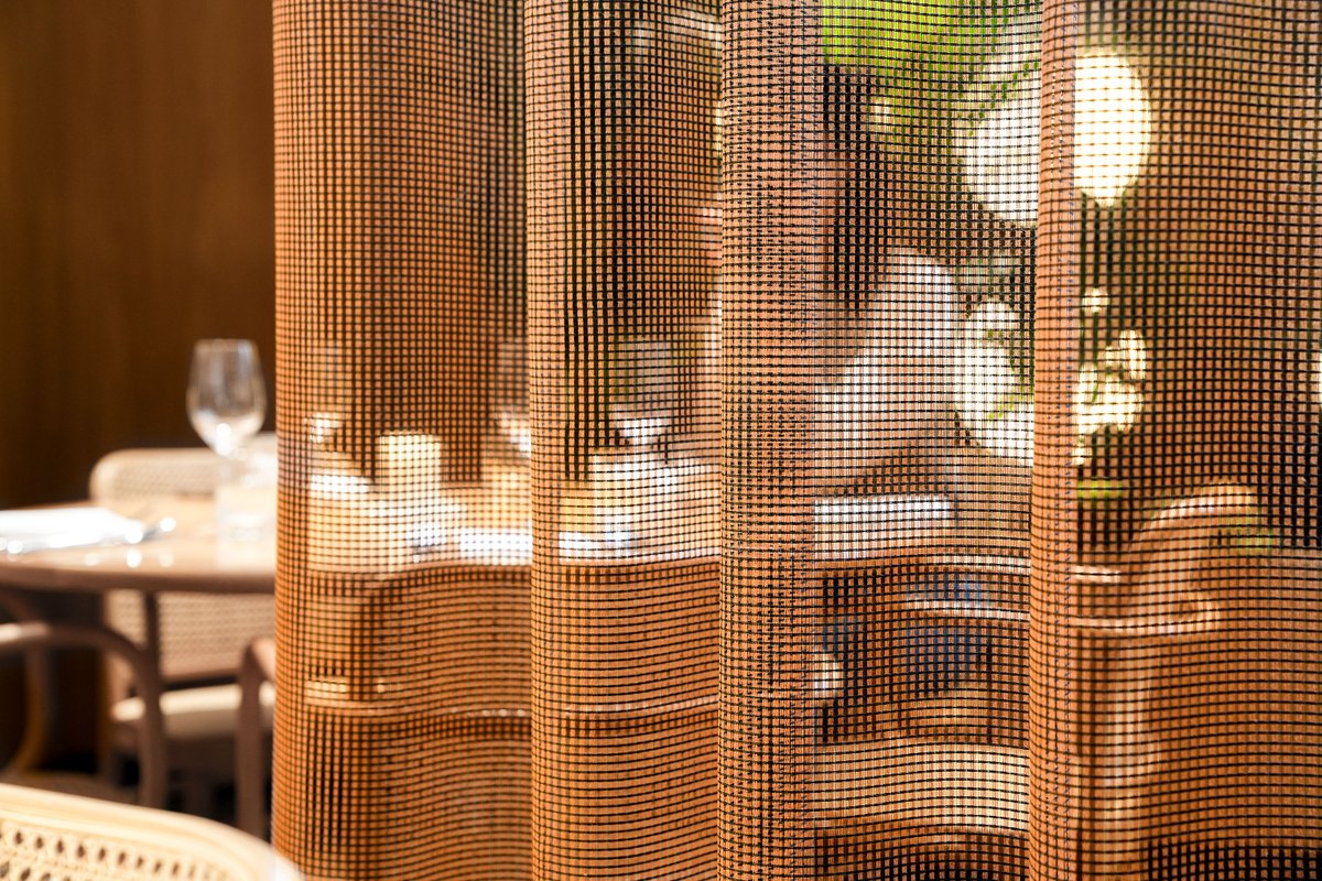 Transparent curtain fabric Teon combines a vivid grid with an open weave, creating an animated play of light, colour and shadow in interiors. Despite its graphic presence, it has an incredible fluidity and a barely-there lightness. Available in 12 colours: hubs.li/Q018SZZV0