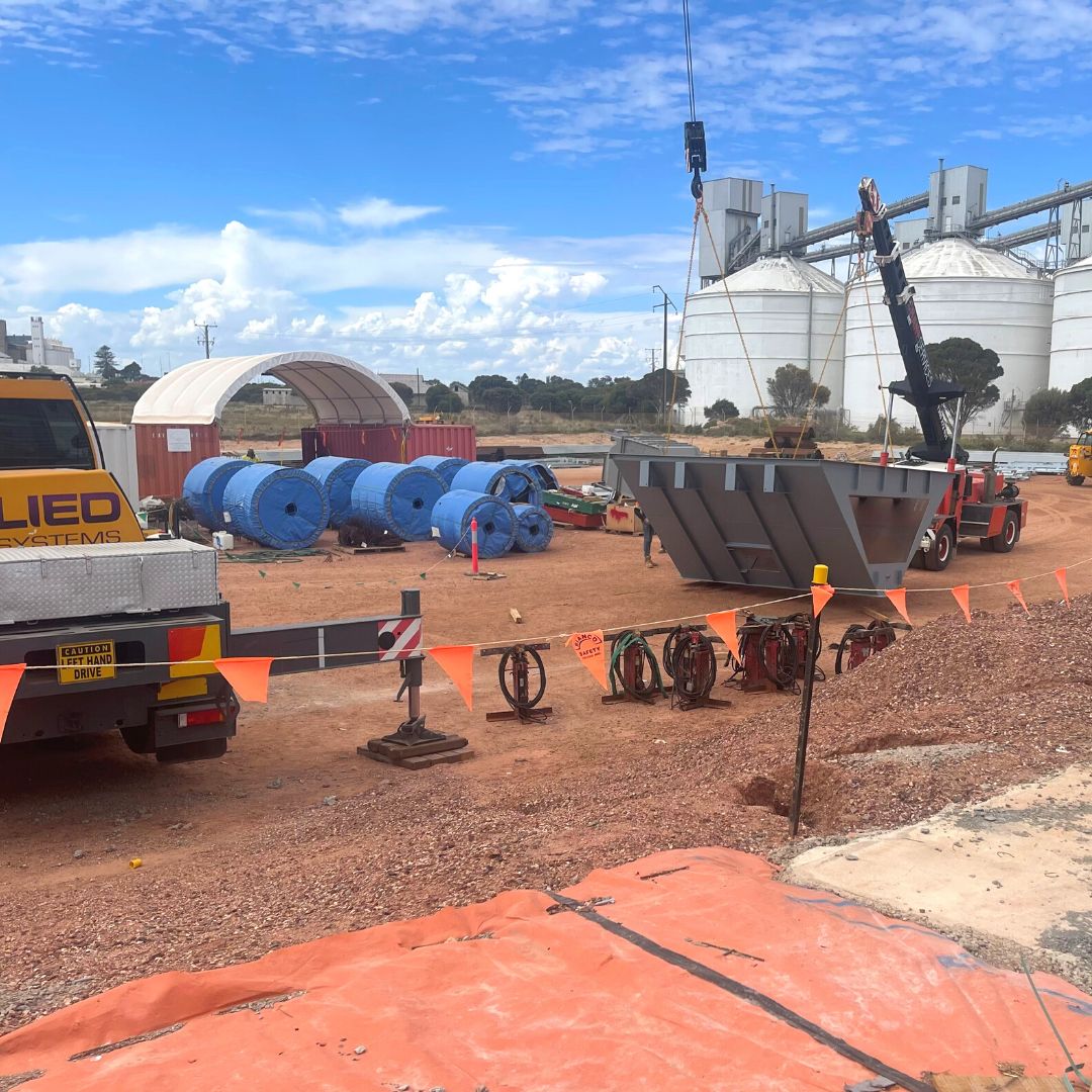 AlliedGrain's tweet photo. Our 30T road drive over hopper being turned from travel position to it's install position. Can you see how little our crew look next to these BIG pieces of equipment on site at @TPortsAus  #WallarooSA  🐜 #AlliedGrainSystems #GrainStorageSolutions #GrainHandlingSolutions #TPorts https://t.co/CNVINnwdxi