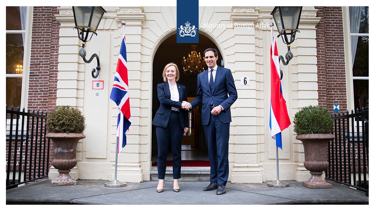 Foreign Secretary Liz Truss left and Minister Hoekstra right shake hands in The Hague.