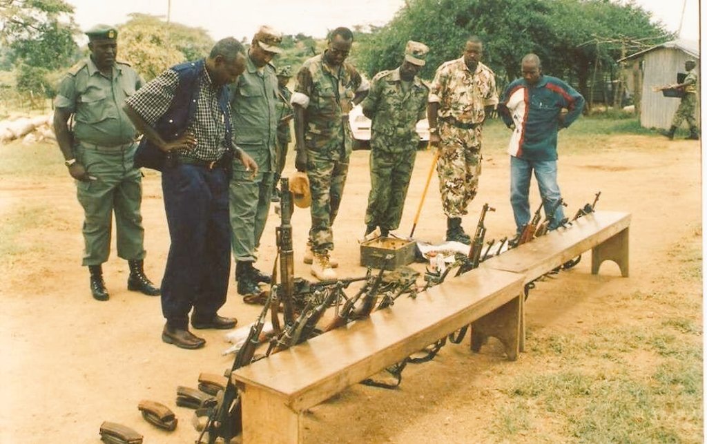 Brig.<a href="/KashakaSteven/">Kashaka Steven</a> (Maj.Gen), Chief of Staff; Col. Poteli Kivuna (RIP), Commander, 2nd Division; Col. H.<a href="/Tumukunde_/">Henry K. Tumukunde</a> (Lt. Gen), Chief Military Intelligence; Capt. Kayanja Muhanga (brown camo, Maj.Gen) &amp; others inspecting arms captured from rebel ADF forces in Kabamba ca. 1997-9.