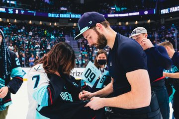 Driedger signing his jersey for a fan