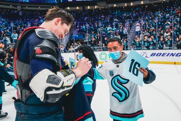 Jared McCann signing a jersey for a fan