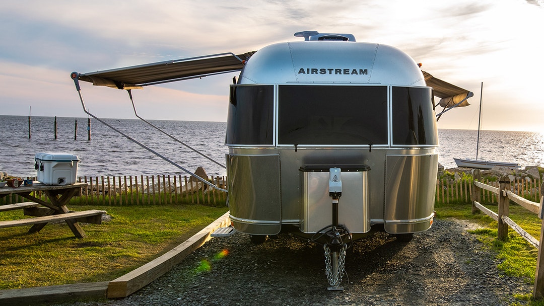 Summer is best spent near the water, with panoramic front and rear windows and all the comforts of home. 🌊 #liveriveted #airstreamadventure