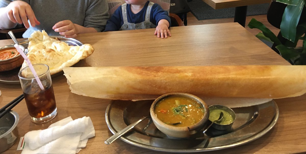 YusukeShinyama's tweet photo. Another year, another giant dosa. (My 7mo son was just watching us eating, sorry!) https://t.co/yI4hPYA1QG