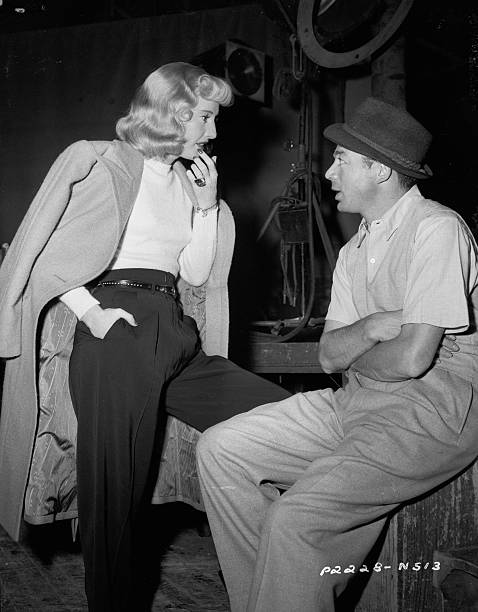 Barbara Stanwyck chats with director Billy Wilder on the set of the classic film noir "Double Indemnity" (1944)    #oldhollywood #classicfilm #filmnoir #noir #barbarastanwyck #vintagehollywood