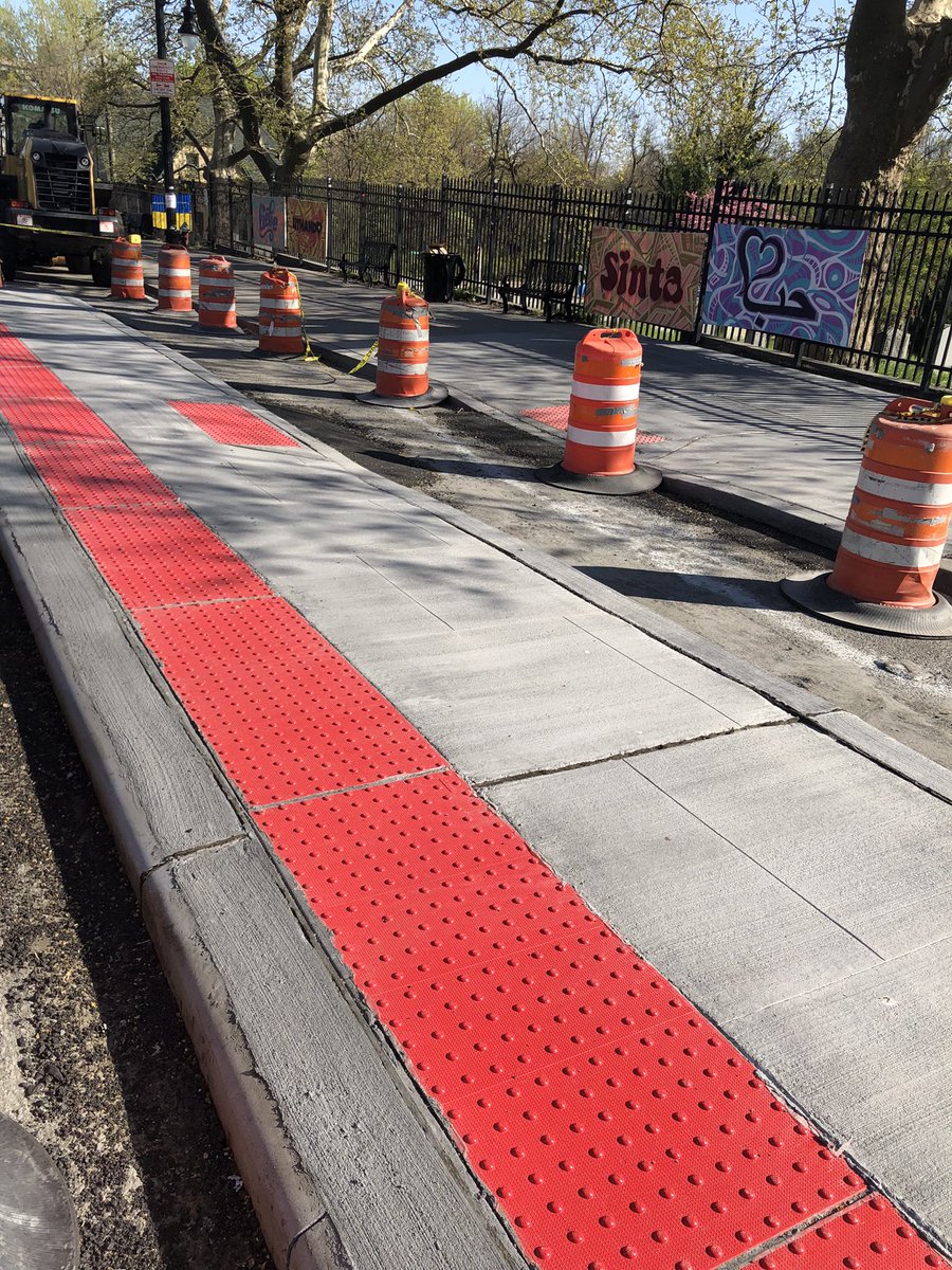 bikejc's tweet photo. A bit of street design history for Jersey City: First “floating bus stop” in JC getting built on the Newark Avenue hill past the cemetery. The channel at right is for a protected bike lane, preventing curbside conflicts with buses and further separating bikes from moving cars. https://t.co/PORf5vSTy1