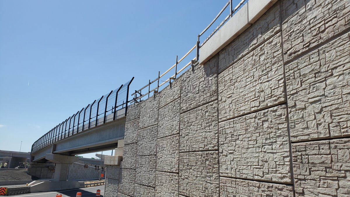 geoquestusa's tweet photo. This pedestrian bridge on the @VaDOT #Transform66 project is nearing completion. Reinforced Earth walls are shown with half-connector top out and temporary fall protection. A CIP parapet will later be cast on top of the coping. https://t.co/CQDVTsgWQr