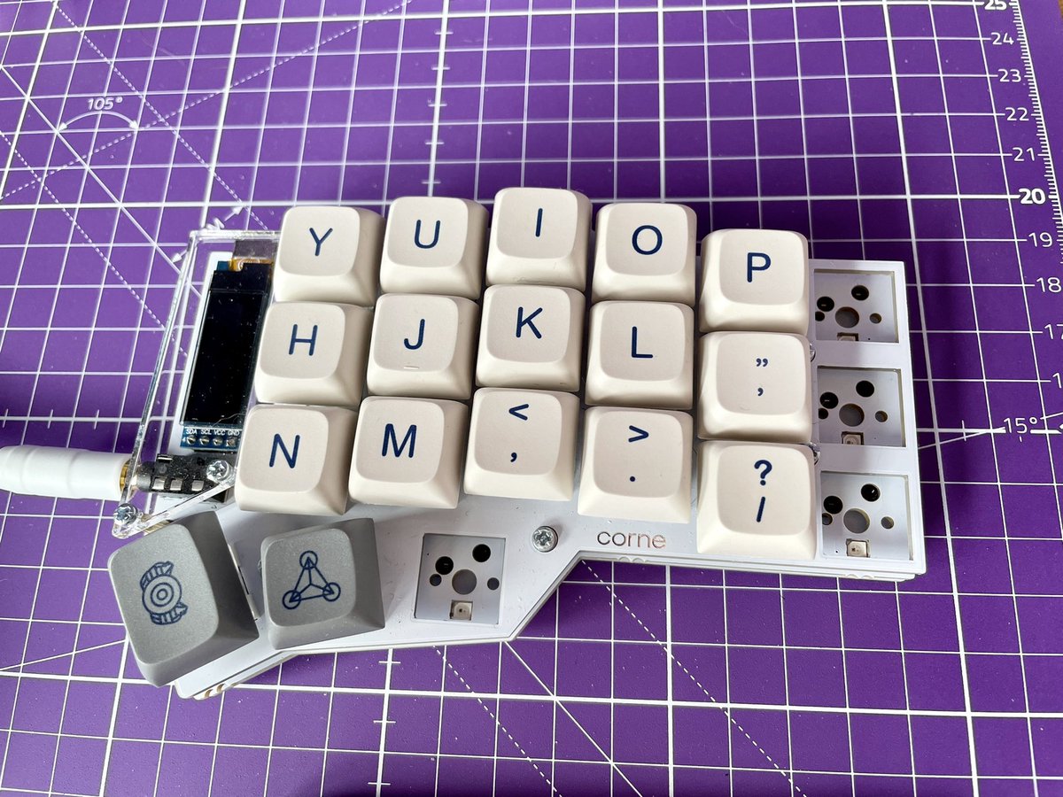 Previous build of keyboard with white switches and dark blue space xda keycaps.
