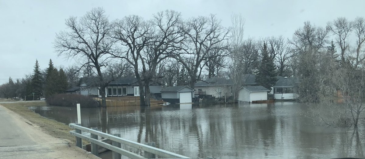 drewkroeker's tweet photo. Water getting high in Sanford, MB. (La Salle River and student parking lot) https://t.co/Ff7hy8oMmC