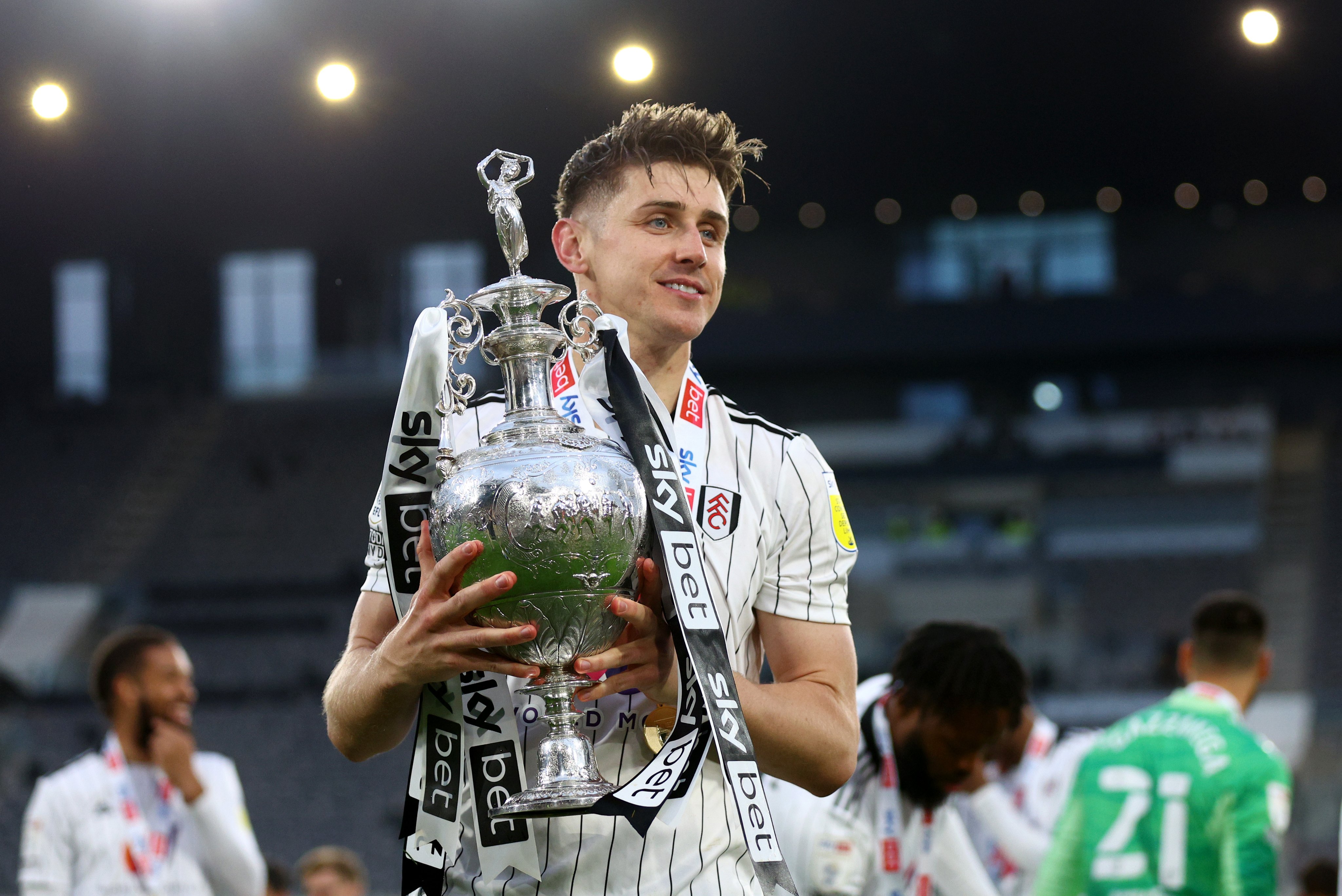 Tom Cairney holds the Sky Bet Championship trophy