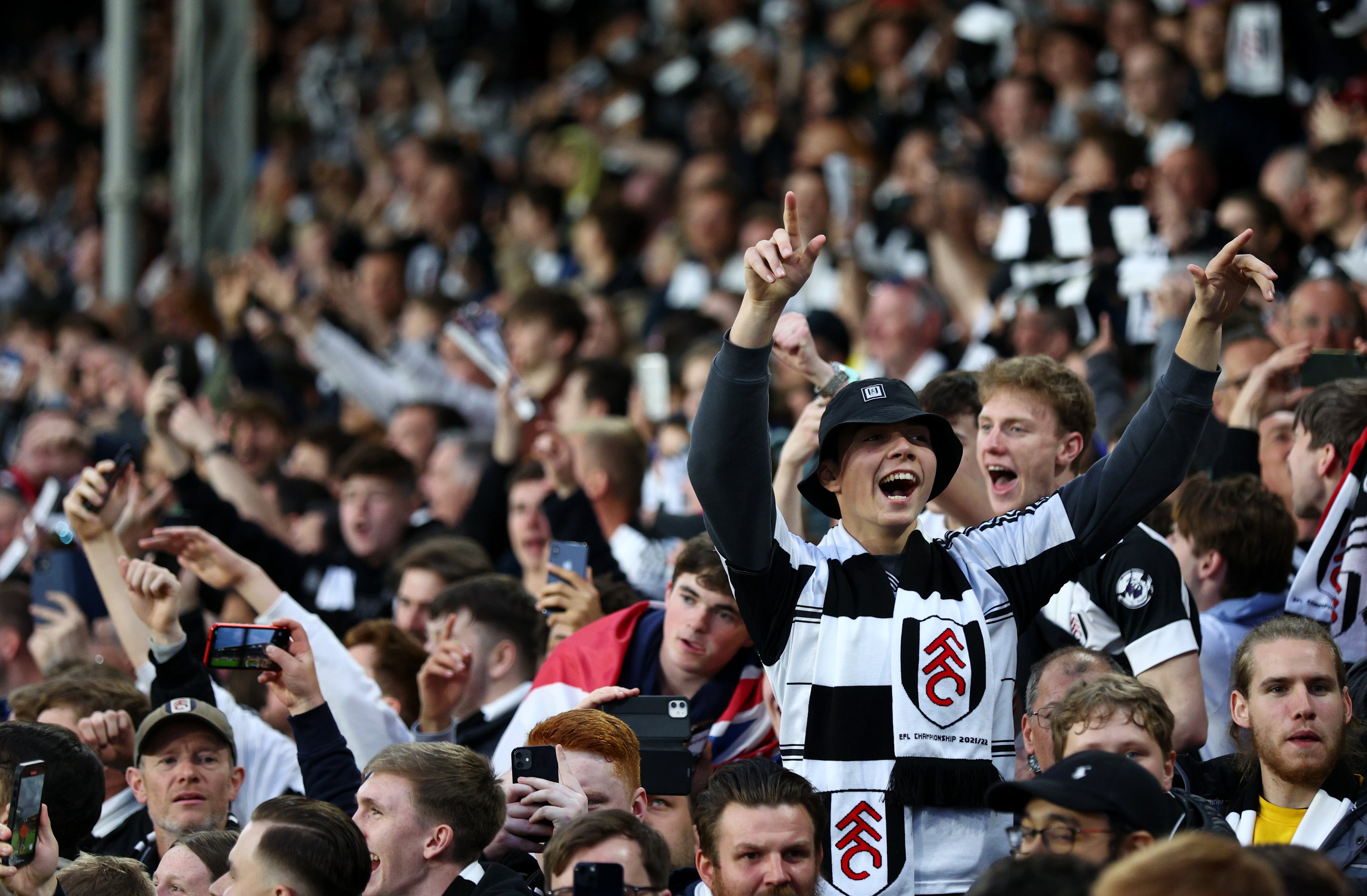 Fulham fans celebrate at the end of the game