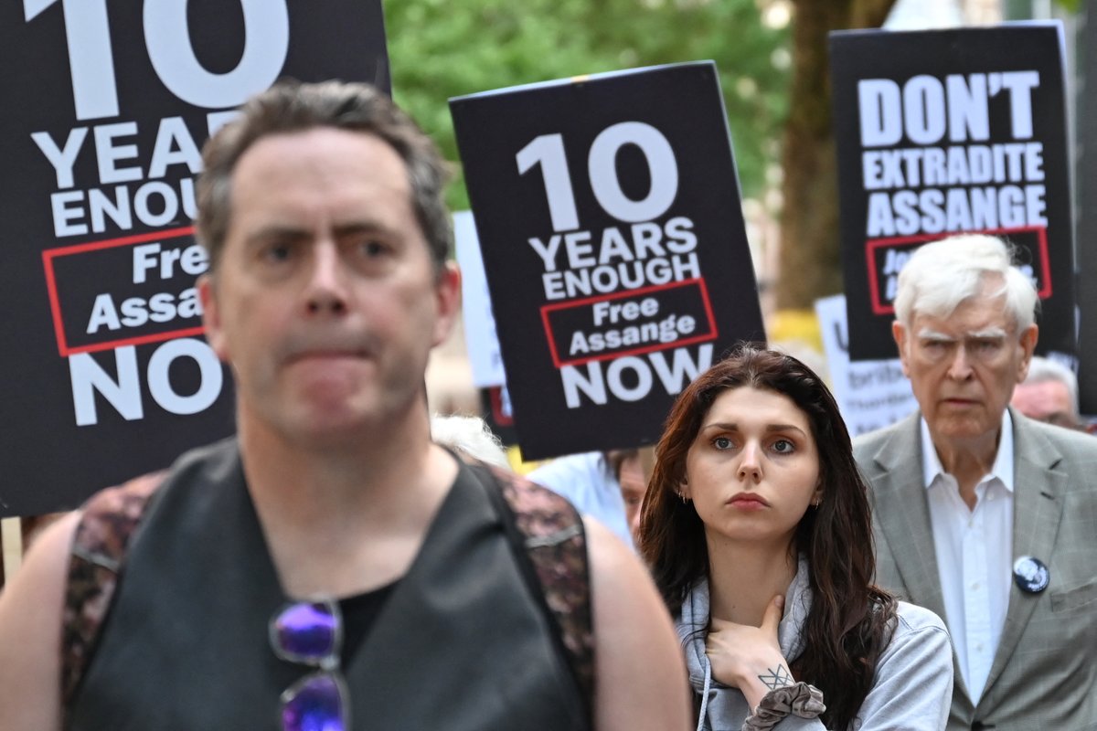 TRTWorldNow's tweet photo. In pictures: Demonstrators hold banners and placards as they gather in front of the Home Office building, in London, during a demonstration to protest against the extradition of WikiLeaks founder Julian Assange to the US https://t.co/gCLIERM7ni