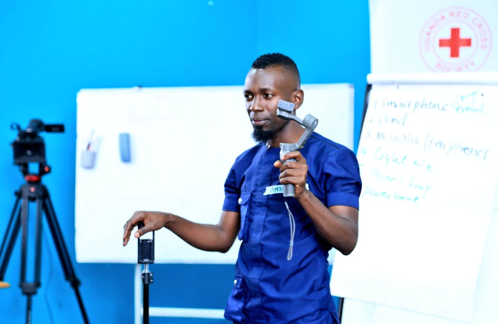 IMChallengeug's tweet photo. .@KisemboAntonio guides the @UgandaRedCross communications volunteers and branch managers on how to set up a mobile journalism (#MOJO) kit during the #MobileStorytellingLab at the @mcimediahub. https://t.co/BAHm3Ww5KM