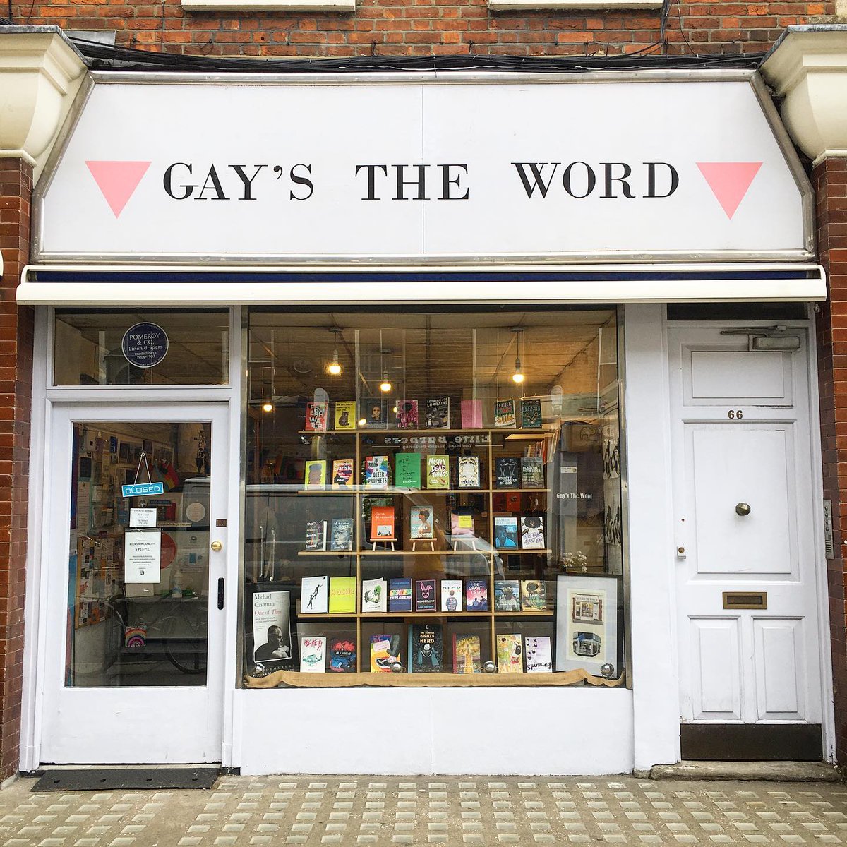he front of Gay’s The Word, an indie bookstore in London. The exterior is white with the store’s name up top. A window display shows a variety of books.