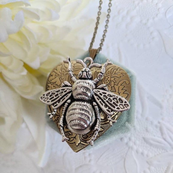 PapillionEra's tweet photo. Bee locket necklace, gold heart locket necklace, https://t.co/5HialzI8oL #beelocket #keepsakegift #goldlocket #heartnecklace #wifegift @etsymktgtool https://t.co/gczWOiXpOA