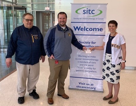 sitcancer's tweet photo. Today, Eric and John from the @Brewers stopped by to spread some #KindnessInMKE and share a generous gift to #SITC with Mary Dean, Executive Director. Thank you for supporting our mission and moving us closer to finding cures for cancer. #MakingCureaReality #immunotherapy https://t.co/Z1EO7qcSbT