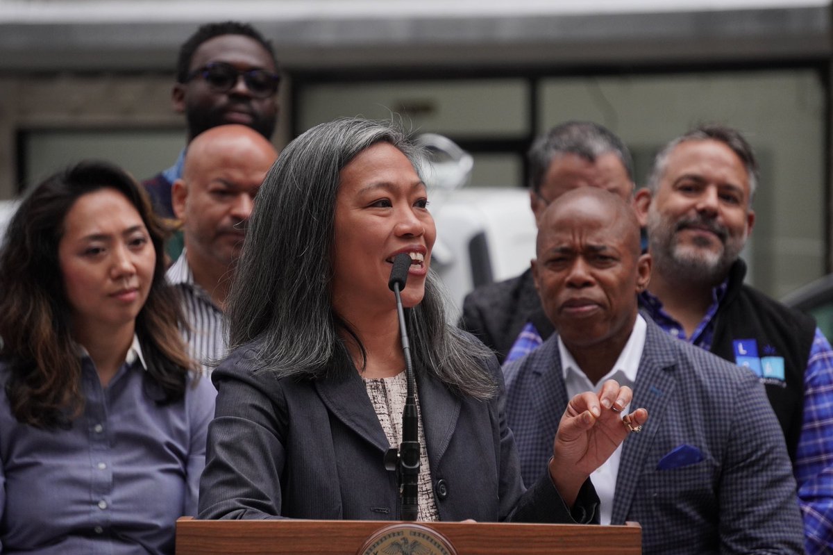 Deputy Mayor Torres-Springer addresses the crowd from the Mayoral podium. Mayor Adams is behind her.