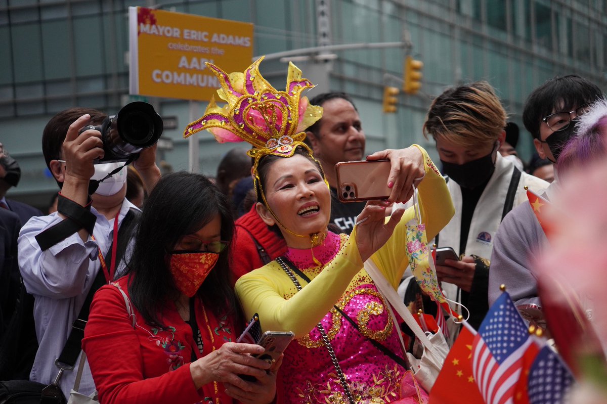 Participants in the parade pose for selfies.