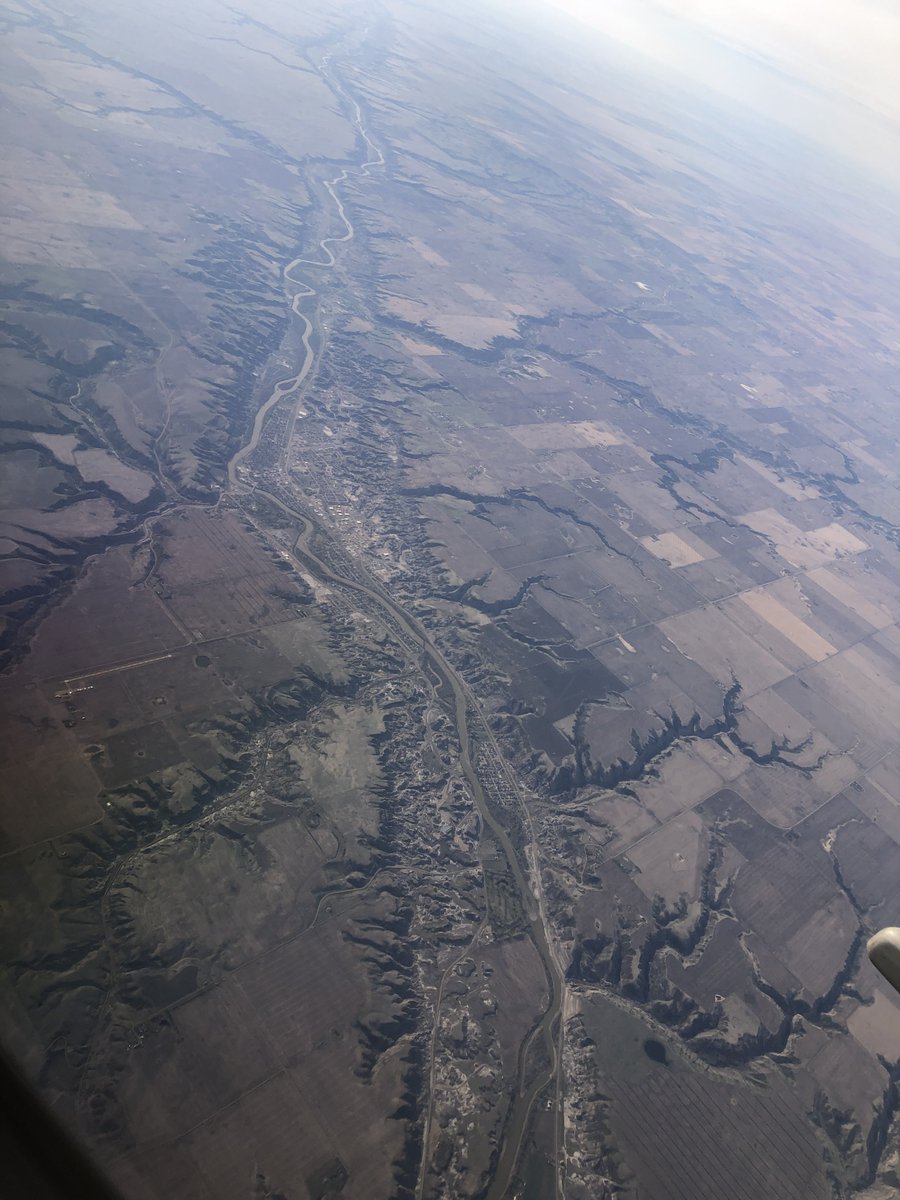KennyDWallace's tweet photo. The Red Deer River and #Drumheller #Alberta, the #Dinosaur Capital of the World. On August 12 1884, Joseph B. Tyrrell stumbled upon a ~70-million-year-old #Albertasaurus skull, the first of its species ever found, just a few km from where the Royal Tyrrell Museum stands today. https://t.co/nnGqxVsozv