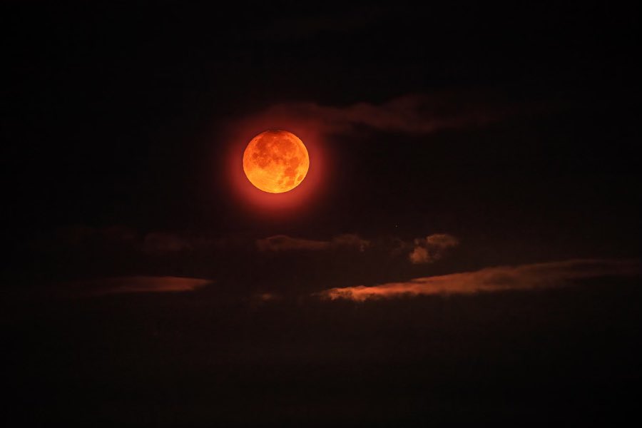 Lava moon sinking around 5:05 am Sunday over Kaluapele.

NPS Photo/J. Wei